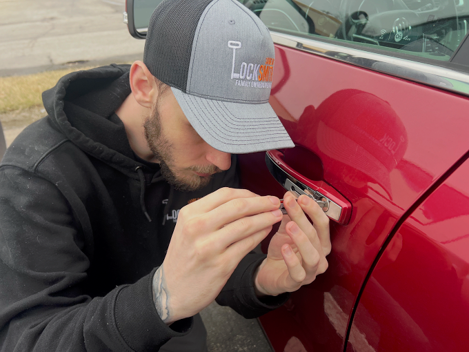 Jake — lead technician working a vehicle door lock